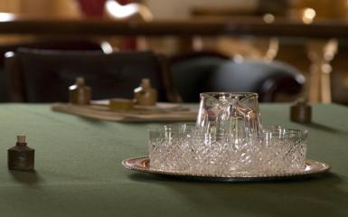 An image of water glasses on a green tablecloth